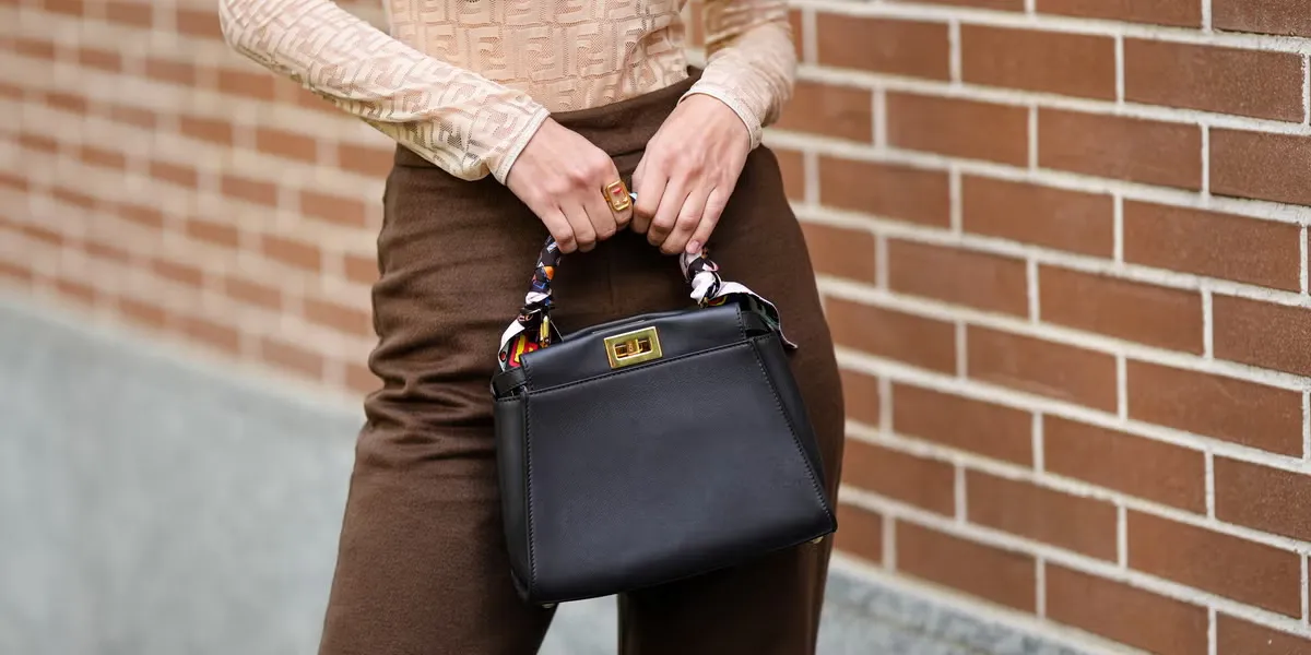 Architectural top-handle bag with crisp geometric structure and minimal hardware detailing.