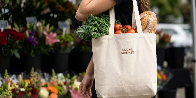 Natural 12 oz cotton canvas tote bag with a two-color screen printed logo