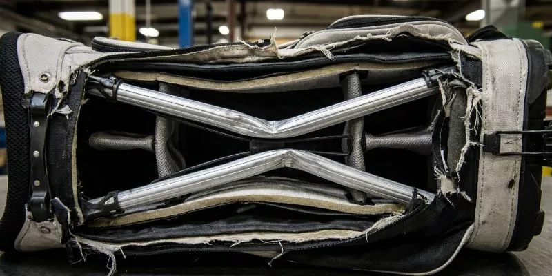 Cross-section of a damaged golf bag showing bent internal aluminum frame