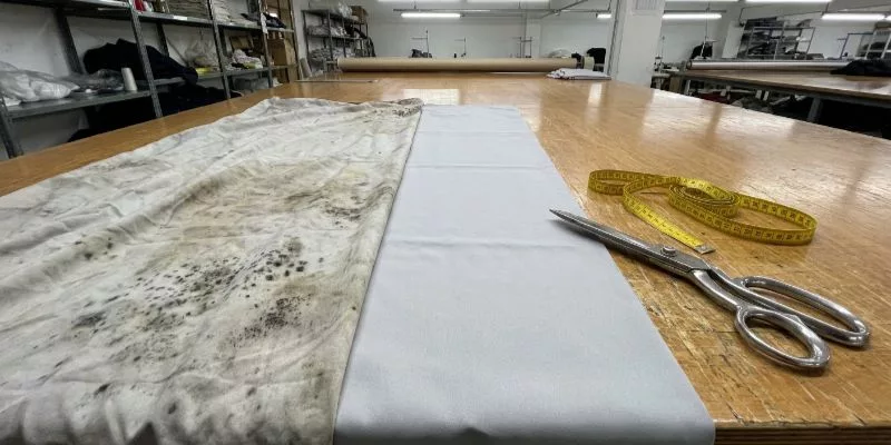 .Moldy generic polyester vs clean silver-ion treated 210D polyester on a factory cutting table