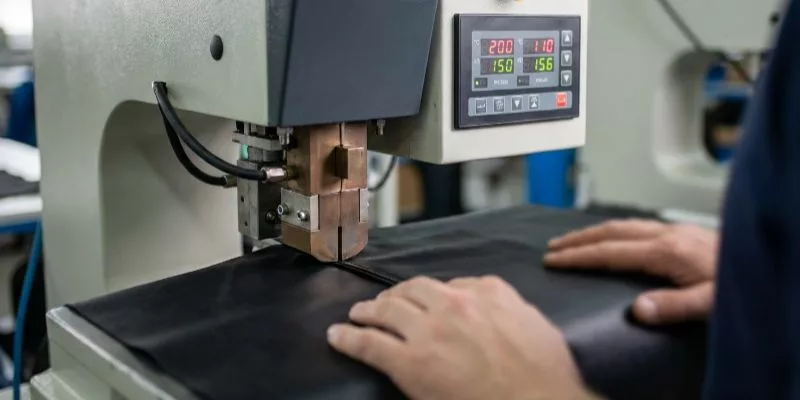High-frequency welding machine fusing waterproof bag seams under precise pressure