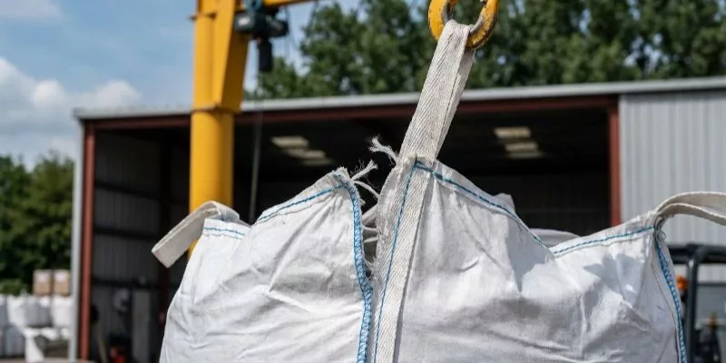 5. FIBC bulk bag suspended by a crane with lifting loops tearing off due to failed sewing thread.