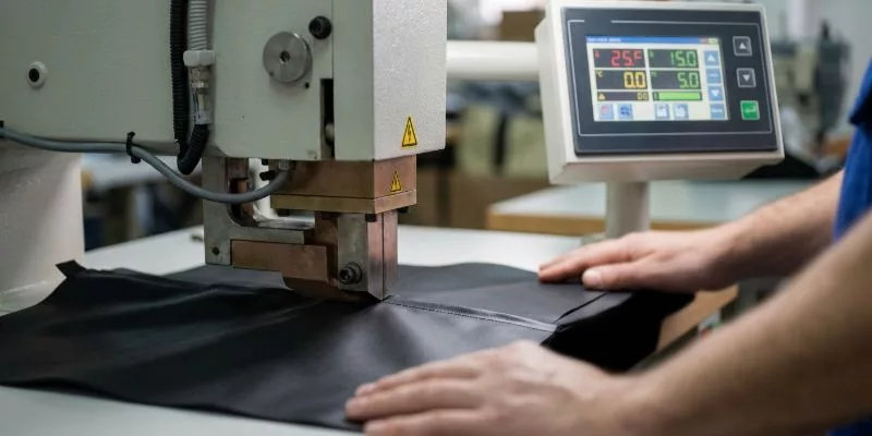 Technical specification sheet and fabric swatches on an engineer's desk for material selection
