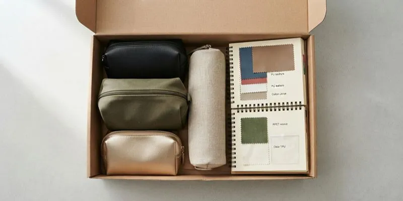 Box of cosmetic bag material swatches in neutral tones