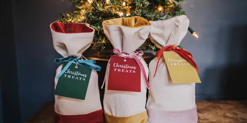 Velvet drawstring gift pouches in red, blue, and cream