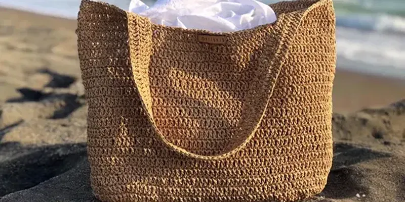 Hand-woven straw beach bag with a fabric lining, styled on the sand