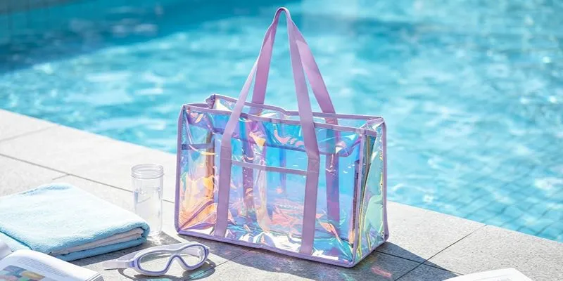 Clear iridescent TPU beach tote with welded seams beside a swimming pool