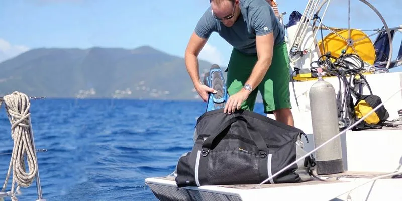 Large classic travel duffle being packed on a boat deck