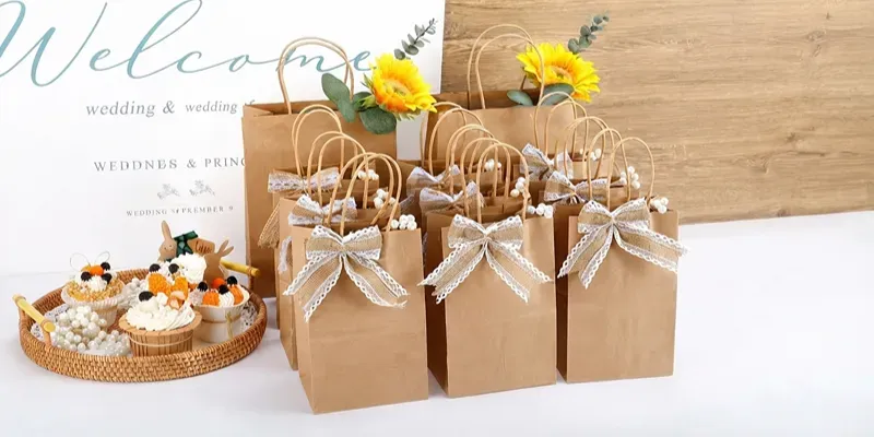 Kraft paper gift bags with twisted paper handles and ribbon bows