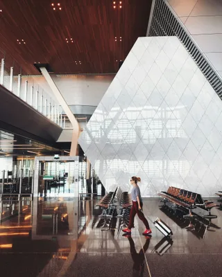 Person walking with luggage inside airport terminal