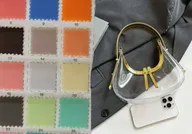 Skilled artisan assembling bags at workbench station