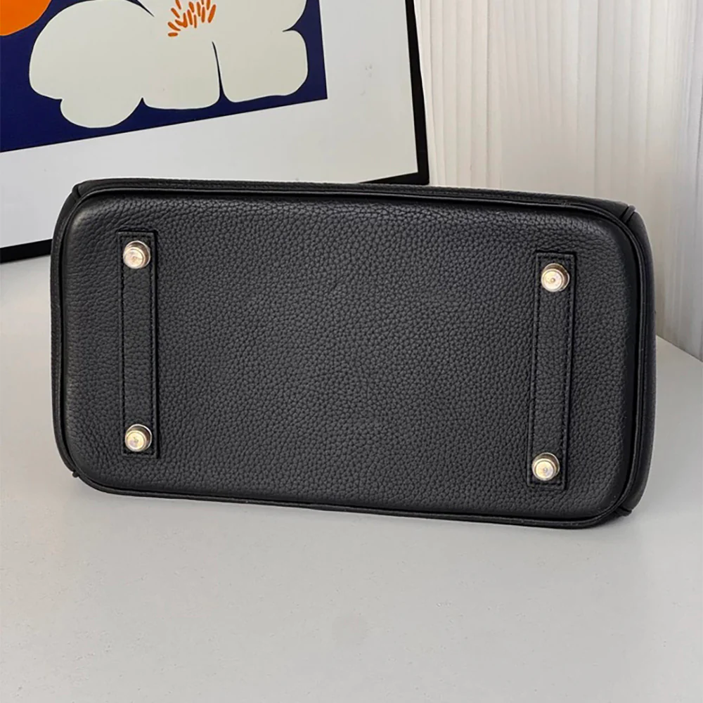 Foot pads and protective metal hardware for bags